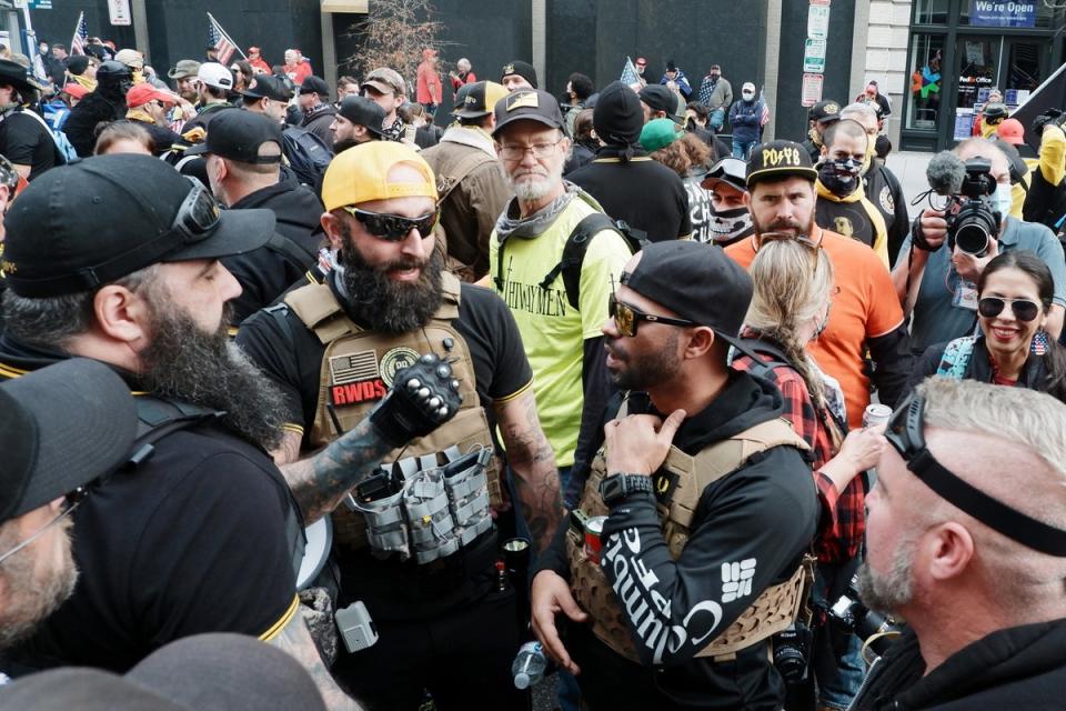 Jeremy Bertino, center left, is pictured with an “RWDS” patch in 2020. (EPA)