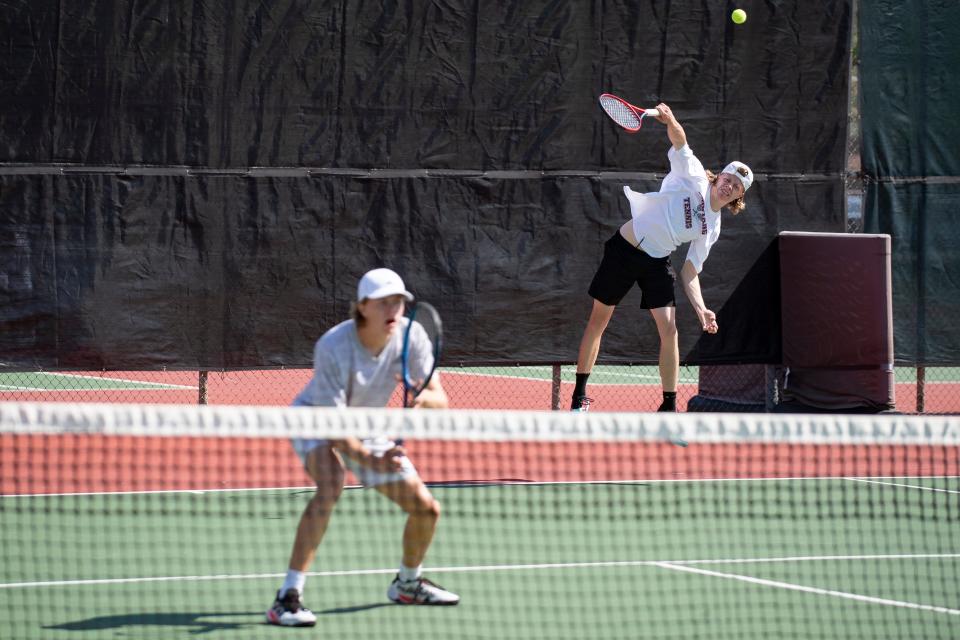 Salina Central Collin Phelps serves Saturday May. 14, 2022, at Kossover Tennis Court in Topeka.