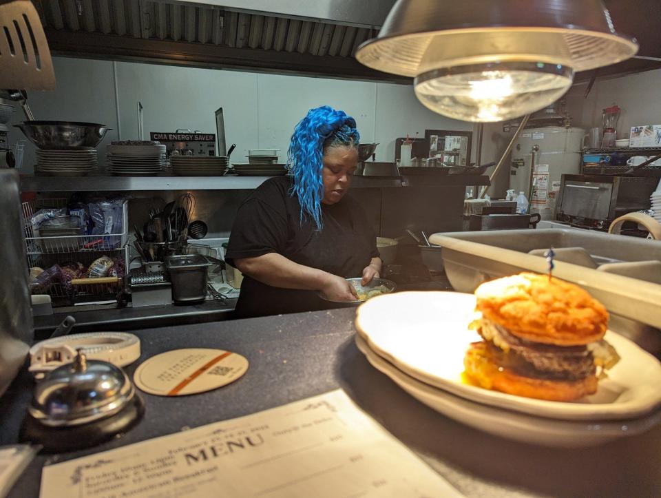 Rienga Breaux working on the sides of a sweet potato sandwich at her breakfast pop-up in The Dehn Bar.