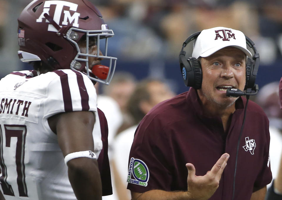 Texas A&M head coach Jimbo Fisher talks with his team as wide receiver Ainias Smith (17) looks on as they play Arkansas during the first half of an NCAA college football game Saturday, Sept. 28, 2019, in Arlington, Texas. Texas A&M won 31-27. (AP Photo/Ron Jenkins)