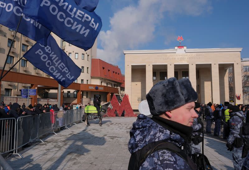 Law enforcement officers stand guard near Luzhniki Stadium ahead of a concert "Glory to the Defenders of the Fatherland" in Moscow