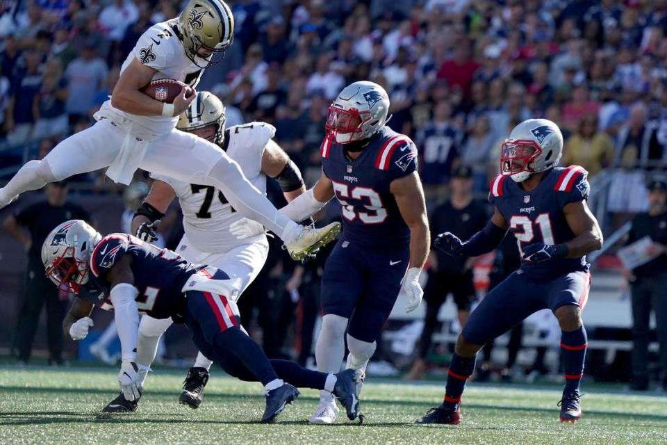 New Orleans Saints quarterback Taysom Hill hurdles New England Patriots free safety Devin McCourty during the second half of their game Sunday in Foxborough, Mass.