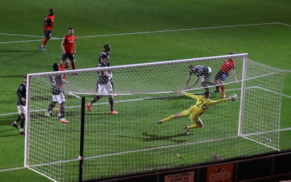 Manchester United's English goalkeeper Dean Henderson saves during the English League Cup third round football match between Luton Town and Manchester United at Kenilworth Road - AFP