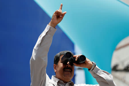 Venezuela's President Nicolas Maduro uses binoculars during a campaign rally in Charallave, Venezuela May 15, 2018. REUTERS/Carlos Garcia Rawlins