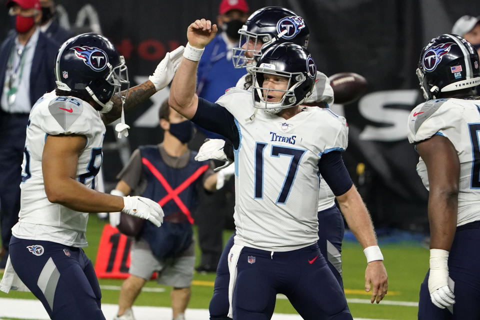 Tennessee Titans quarterback Ryan Tannehill (17) celebrates with MyCole Pruitt (85) after running for a touchdown against the Houston Texans during the second half of an NFL football game Sunday, Jan. 3, 2021, in Houston. (AP Photo/Eric Christian Smith)