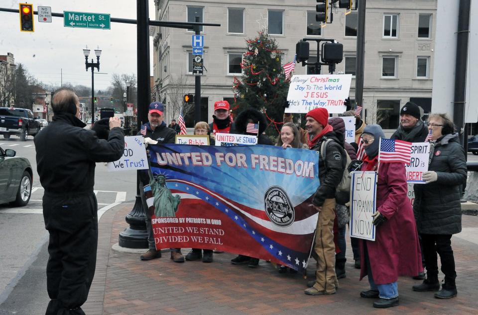 A second group of protesters takes a photo at the Wooster city square on Jan. 6.