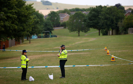 Police officers stand next to a section of playing field near Amesbury Baptist Church, which has been cordoned off after two people were hospitalised and police declared a 'major incident', in Amesbury, Wiltshire, Britain, July 4, 2018. REUTERS/Henry Nicholls