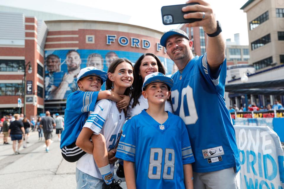 Detroit Lions fans from left: Tillman Doyle, 7, Mia Doyle, 12 Easton Doyle, 10 and their parents Jenny and Kevin Doyle all of Phoenix, Ariz. take a selfie outside of Ford Field in Detroit on Sunday, Sept. 12, 2021 before the opener vs. the San Francisco 49ers.