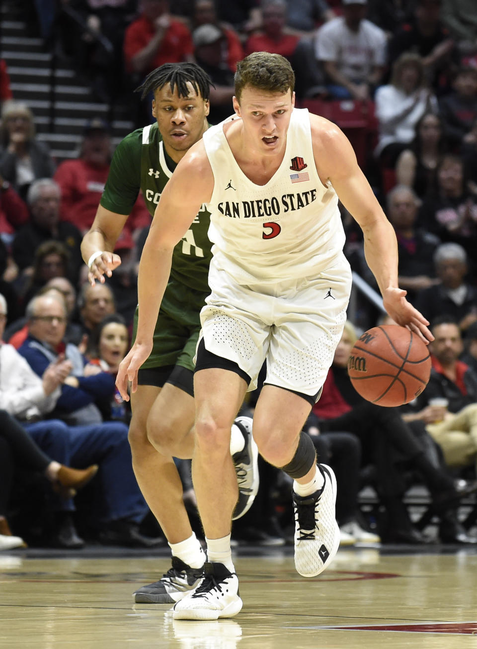 San Diego State forward Yanni Wetzell (5) steals the ball from Colorado State forward Dischon Thomas (11) during the first half of an NCAA college basketball game Tuesday, Feb. 25, 2020, in San Diego. (AP Photo/Denis Poroy)