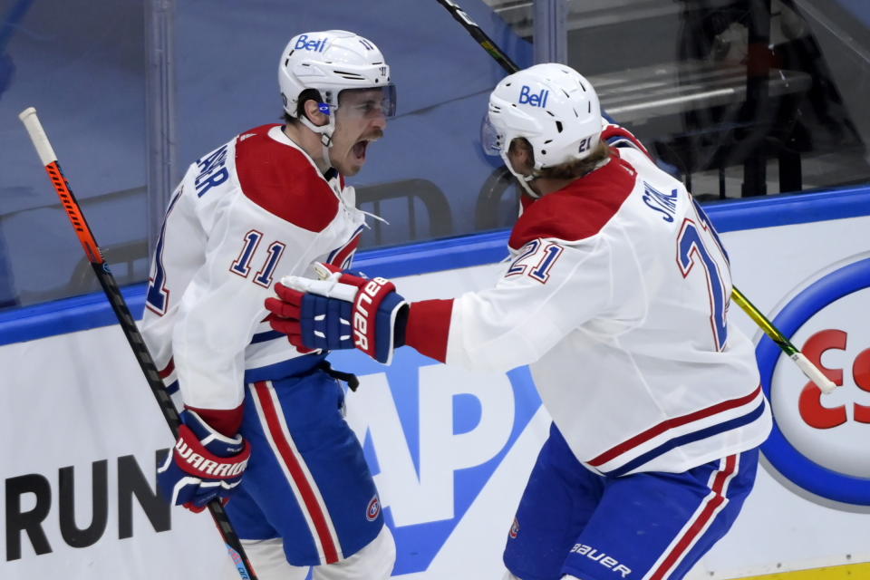 Montreal Canadiens forward Brendan Gallagher (11) celebrates his goal with teammate Eric Staal (21) during second period NHL Stanley Cup hockey action against the Toronto Maple Leafs, in Toronto, Monday, May 31, 2021. (Nathan Denette/The Canadian Press via AP)
