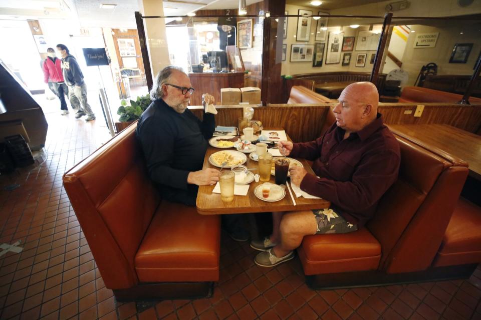 Regular customers Kelly Cox, left, and Rick Ingold enjoy an indoor breakfast at Canter's Delicatessen.