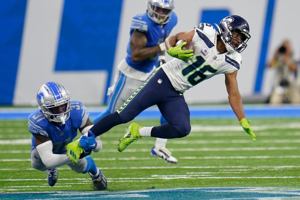 Seahawks wide receiver Tyler Lockett is stopped by Lions safety Kerby Joseph during the second half of the Lions' 48-45 loss on Sunday, Oct. 2, 2022, at Ford Field.