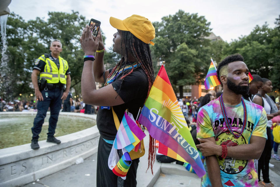 People watch the conclusion of the Capitol Pride Parade at Dupont Circle in Washington, Saturday, June 8, 2019. (AP Photo/Andrew Harnik)