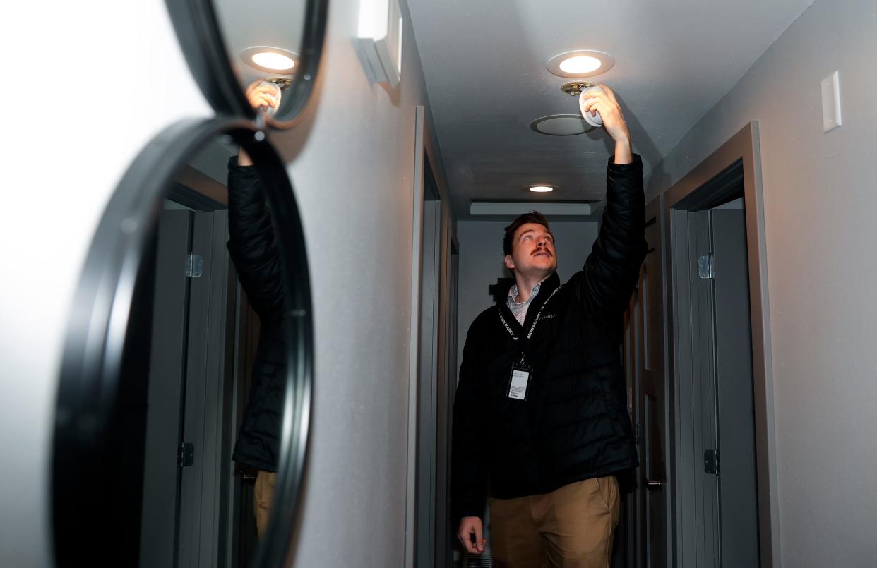 Steven Seitz, Brown County public health sanitarian, examines a smoke detector while completing a routine short-term rental inspection at 2029 True Lane on March 31, 2023, in Ashwaubenon, Wis.