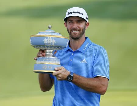 Mar 26, 2017; Austin, TX, USA; Dustin Johnson of the United States holds up The Walter Hagen Trophy after beating Jon Rahm of Spain in the final round of the World Golf Classic - Dell Match Play golf tournament at Austin Country Club. Mandatory Credit: Erich Schlegel-USA TODAY Sports