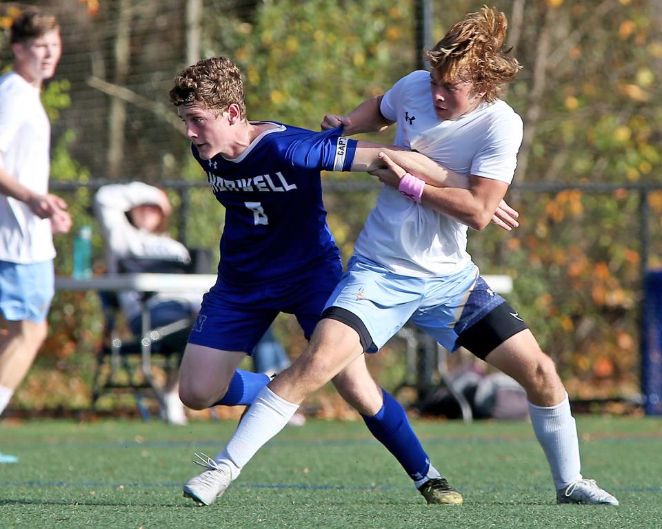 East Bridgewater's Jackson Rix gets a hold of Norwell's Caleb White while they battle for possession during second half action of their Round of 32 game against Norwell in the Division 3 state tournament at the Norwell Clipper Community Complex on Saturday, Nov. 5, 2022. Norwell would go on to win 3-0.