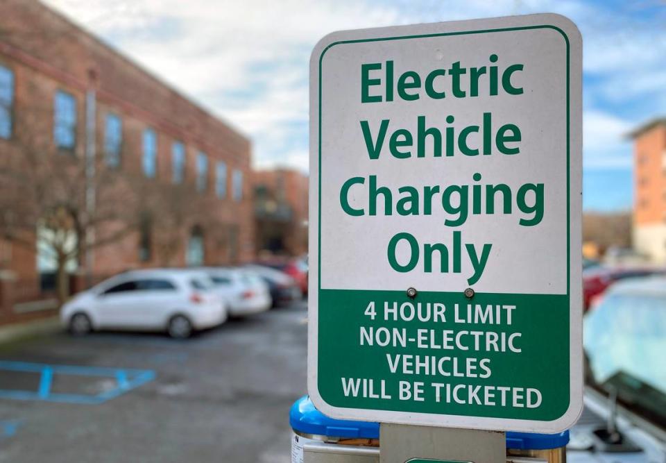 An electric vehicle charging station in a parking area along Broadway near Ninth Street in downtown Columbus, Georgia