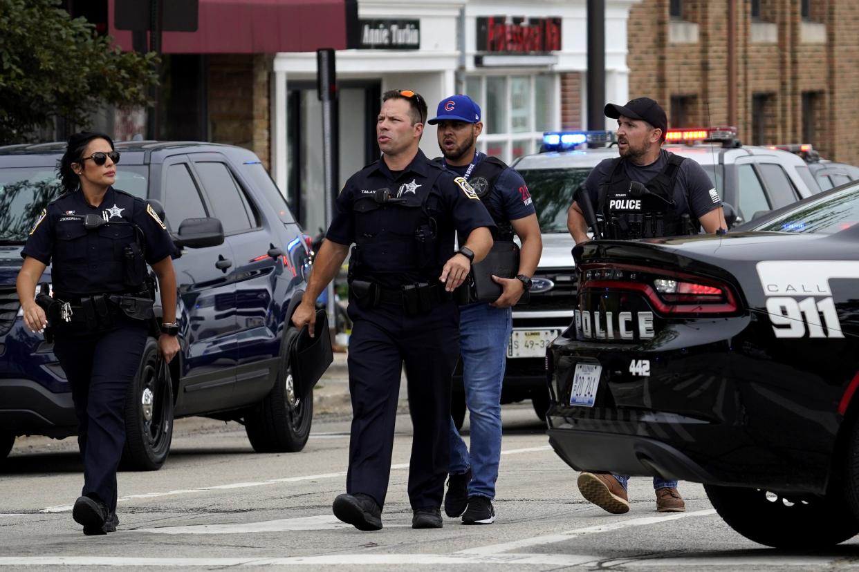 Police search the downtown area in Highland Park after a shooting at a Fourth of July parade, Monday, July 4, 2022. 