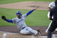 Toronto Blue Jays' Isiah Kiner-Falefa scores from third base on a wild pitch during the second inning of a baseball game against the San Diego Padres, Saturday, April 20, 2024, in San Diego. (AP Photo/Gregory Bull)