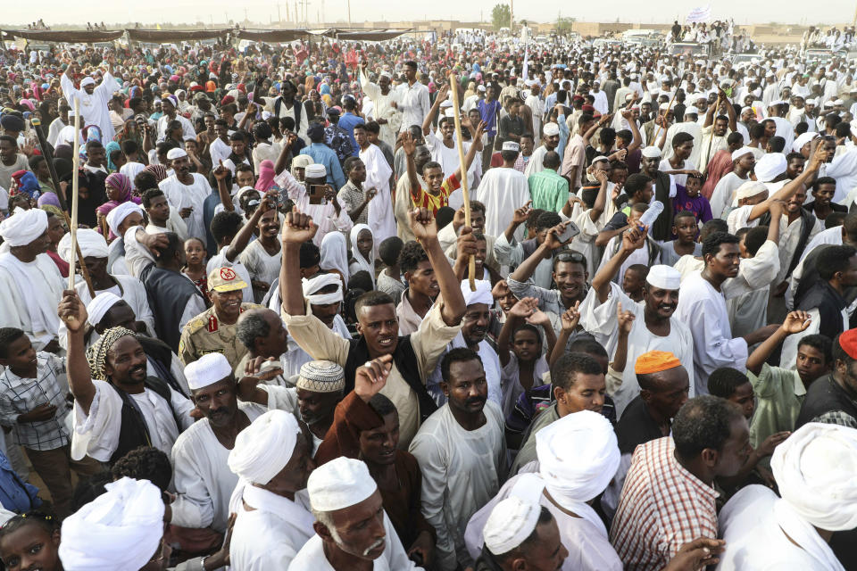 A crowd gathers as Gen. Mohammed Hamdan Dagalo, the deputy head of the military council, speaks during a military-backed tribe's rally, in the Nile River State, Sudan, Saturday, , on July 13, 2019. . (AP Photo/Mahmoud Hjaj)