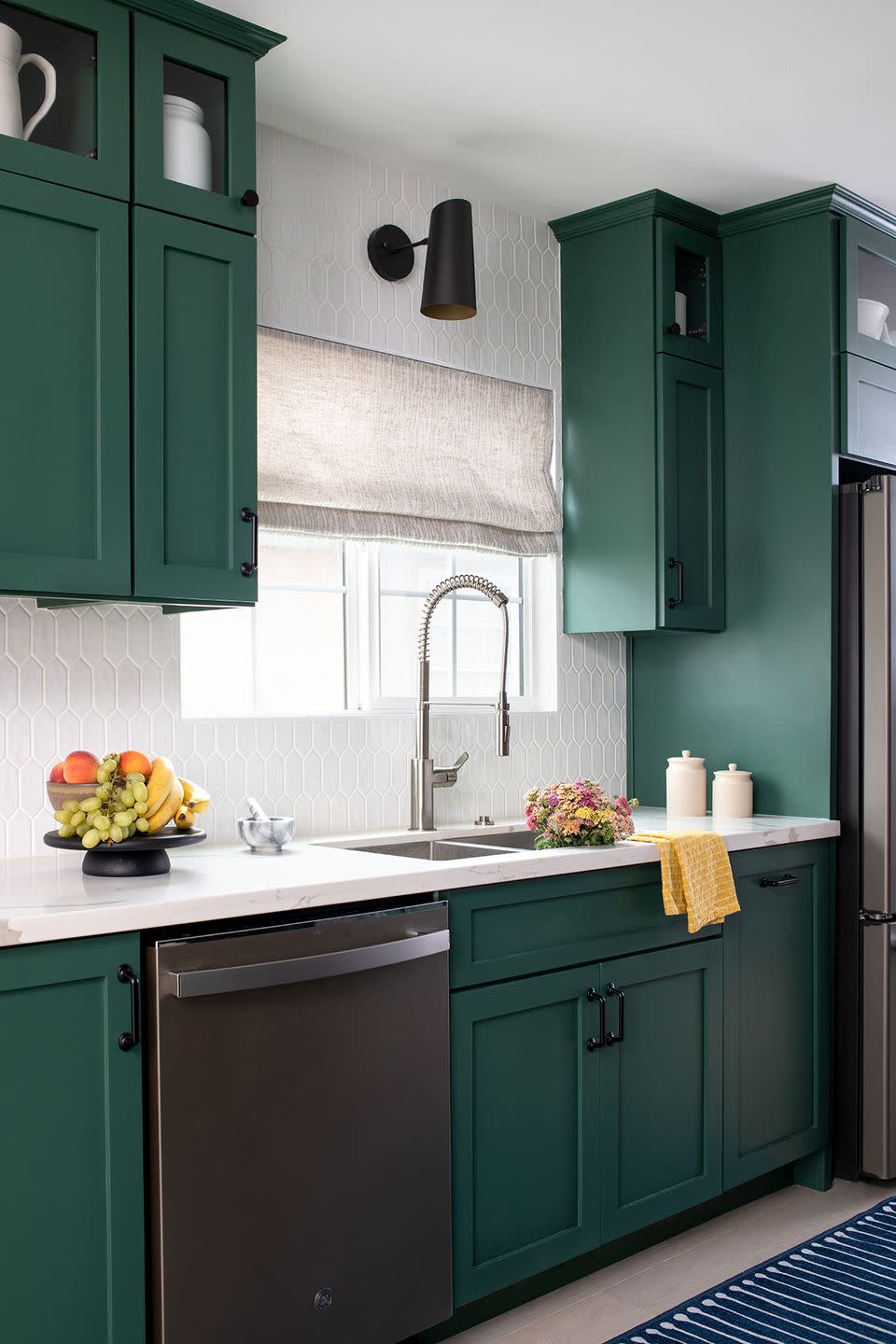 a kitchen with green cabinets