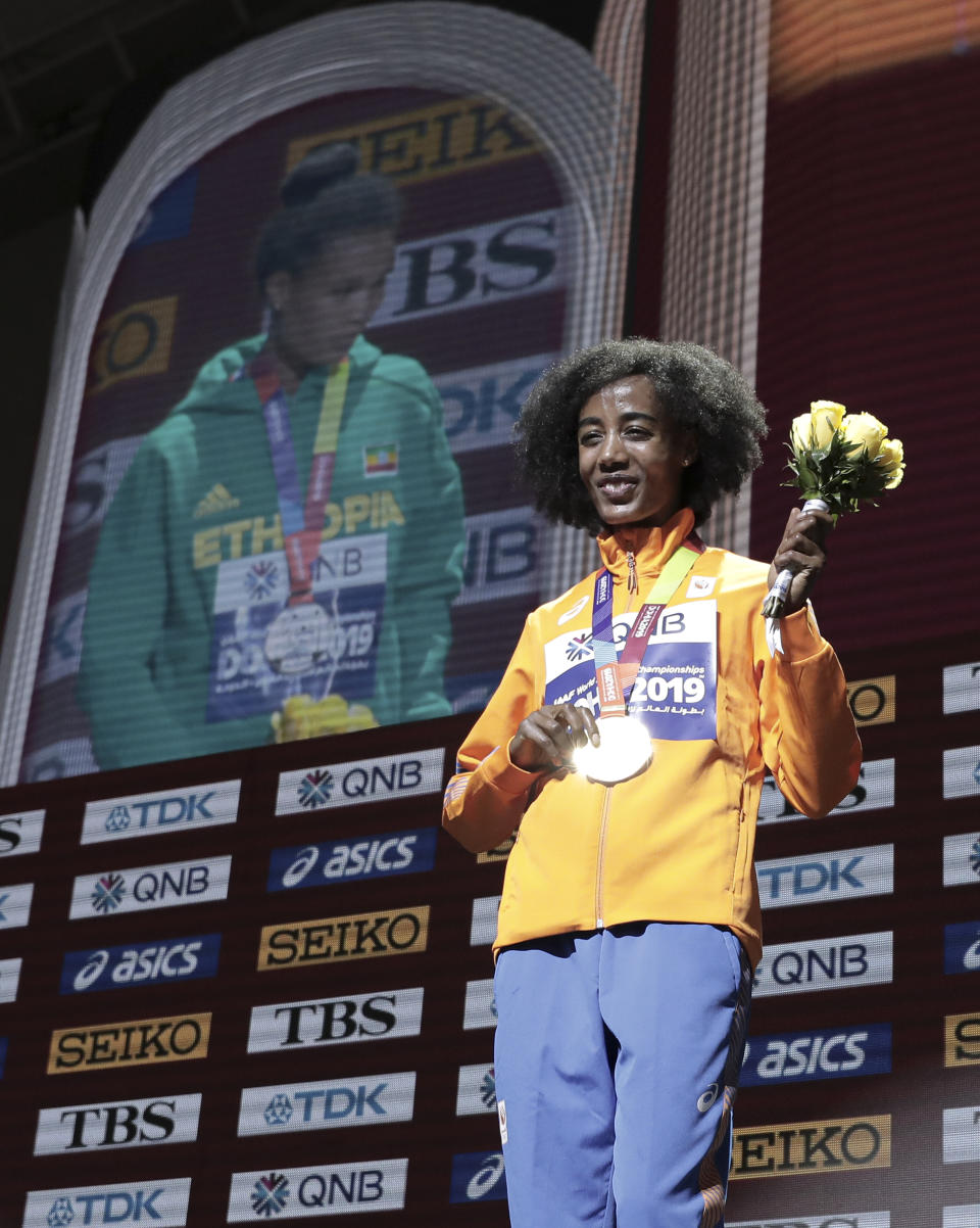 Sifan Hassan of the Netherlands, gold winner, poses during the medal ceremony for the women's 10,000m final at the World Athletics Championships in Doha, Qatar, Sunday, Sept. 29, 2019. (AP Photo/Nariman El-Mofty)