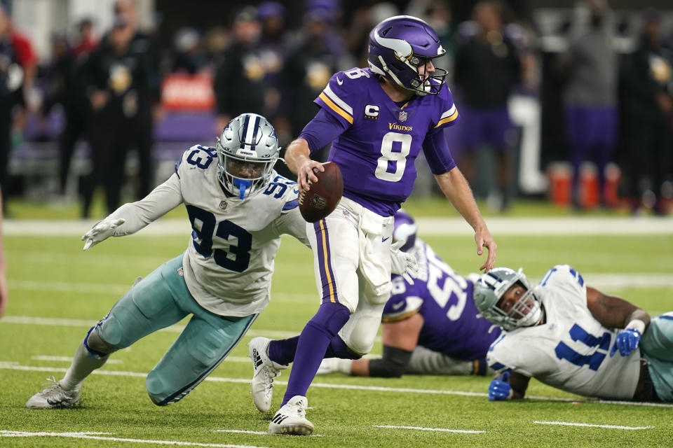 Minnesota Vikings quarterback Kirk Cousins (8) runs from Dallas Cowboys defensive end Tarell Basham (93) during the second half of an NFL football game, Sunday, Oct. 31, 2021, in Minneapolis. The Cowboys won 20-16. (AP Photo/Jim Mone)