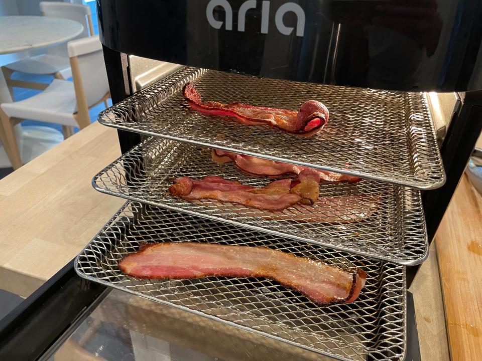 cooked bacon on racks in an air fryer