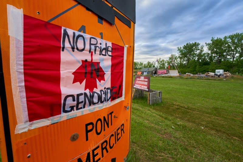 A Canadian flag is hung up side down as a protest for the 215 children buried in an unmarked mass grave on the grounds of the former Kamloops Indian Residential School in Kahnawake reserve, Canada, in 2021. File Photo by Andre Pichette/EPA-EFE