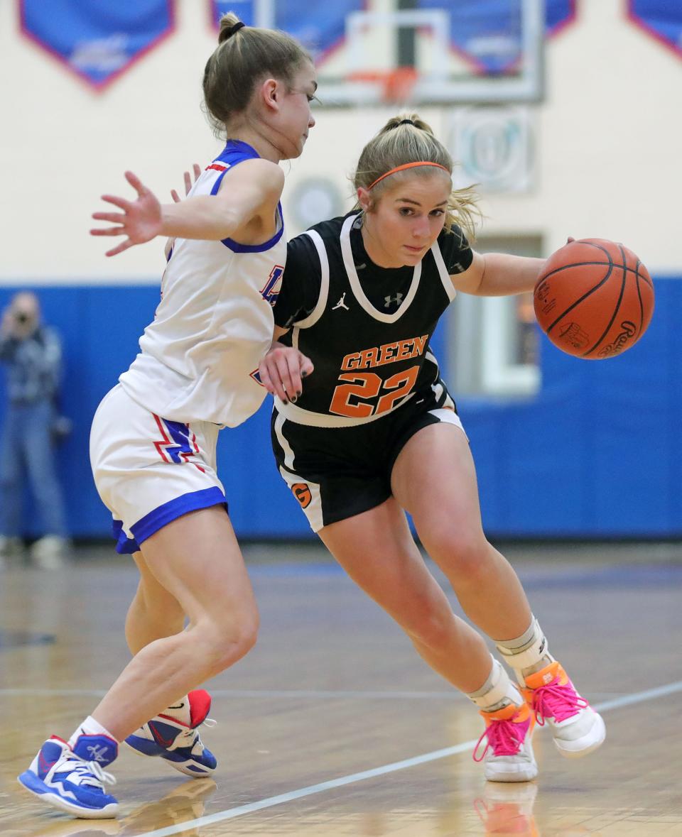 Green's Nina Shaffer, right, takes the ball down the court against Lake's Emma Anderson during the first half of a basketball game, Wednesday, Jan. 25, 2023, in Uniontown, Ohio.