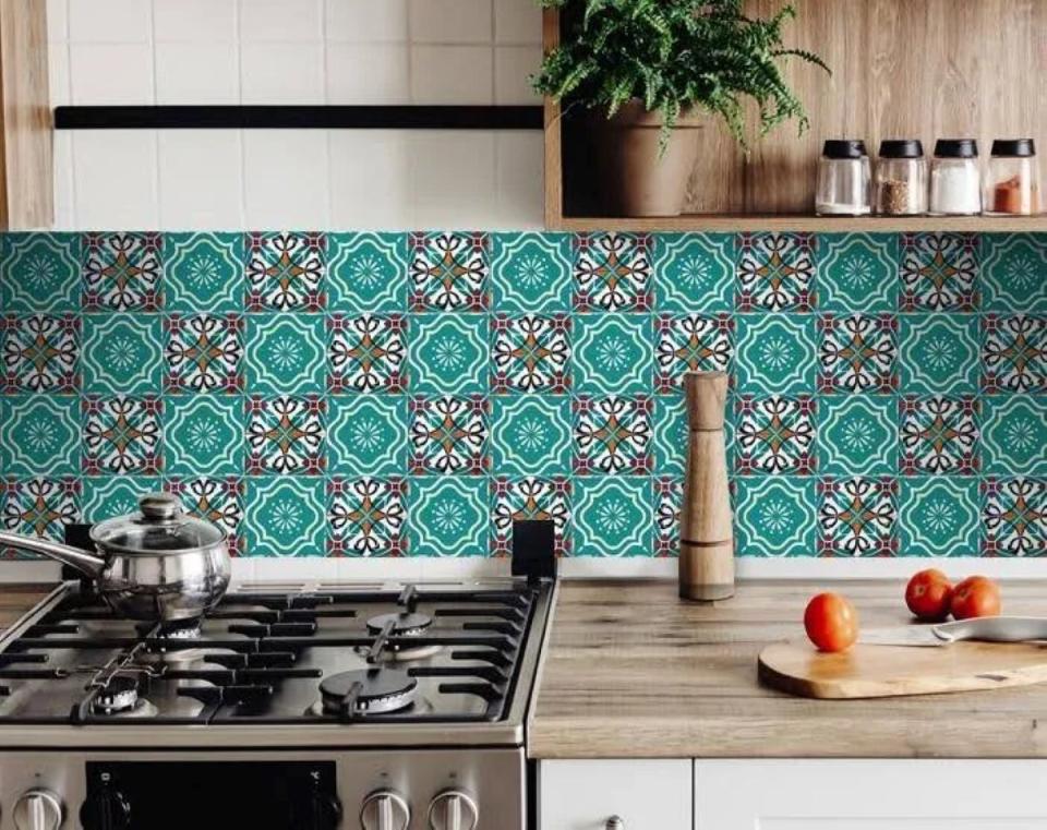 Colorful patterned kitchen backsplash with shades of aqua and black.