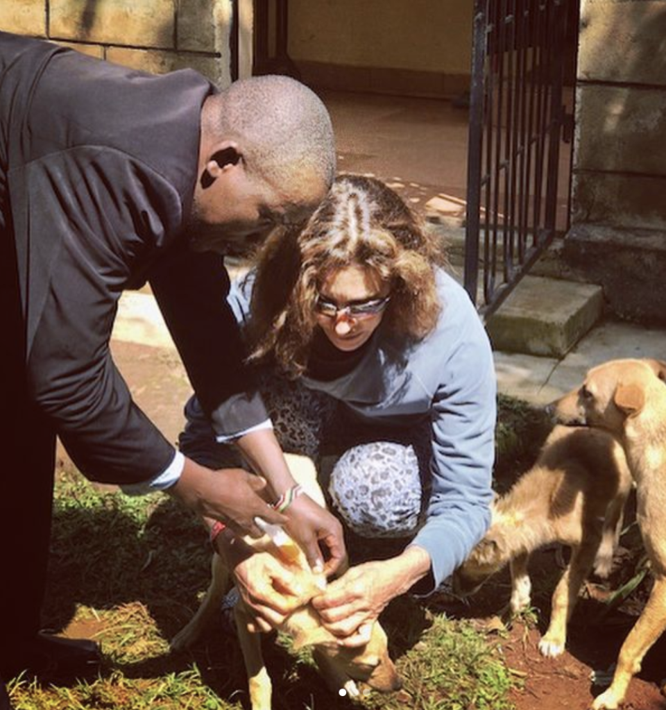 a man and woman petting a dog