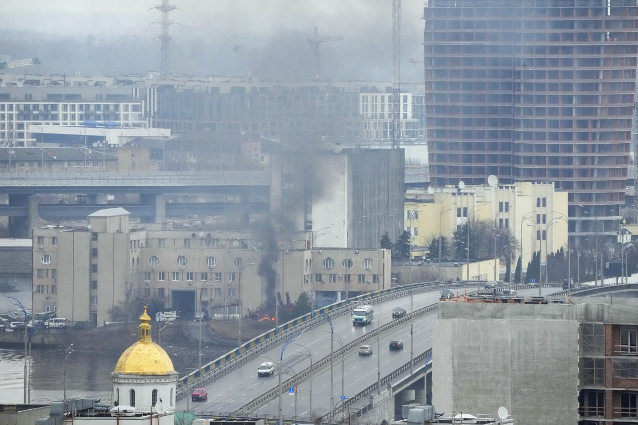 Smoke and flame rise near a military building after an apparent Russian strike in Kyiv, Ukraine, Thursday, Feb. 24, 2022. Russian troops have launched their anticipated attack on Ukraine. Big explosions were heard before dawn in Kyiv, Kharkiv and Odesa as world leaders decried the start of an Russian invasion that could cause massive casualties and topple Ukraine's democratically elected government. (AP Photo/Efrem Lukatsky)