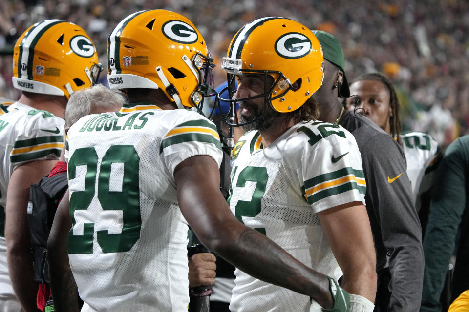 Green Bay Packers cornerback Rasul Douglas (29) celebrates his interception in the end zone with quarterback Aaron Rodgers (12) during the second half of an NFL football game against the Arizona Cardinals, Thursday, Oct. 28, 2021, in Glendale, Ariz. The Packers won 24-21. (AP Photo/Rick Scuteri)