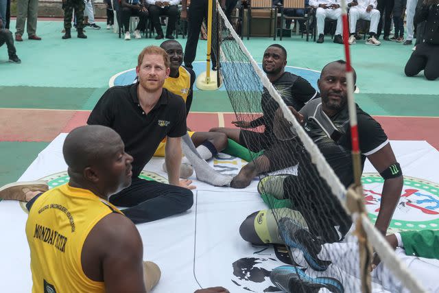 <p>KOLA SULAIMON/AFP via Getty</p> Prince Harry takes part in a sitting volleyball match at Nigeria Unconquered, a local charity organisation that supports wounded, injured, or sick servicemembers, in Abuja on May 11, 2024