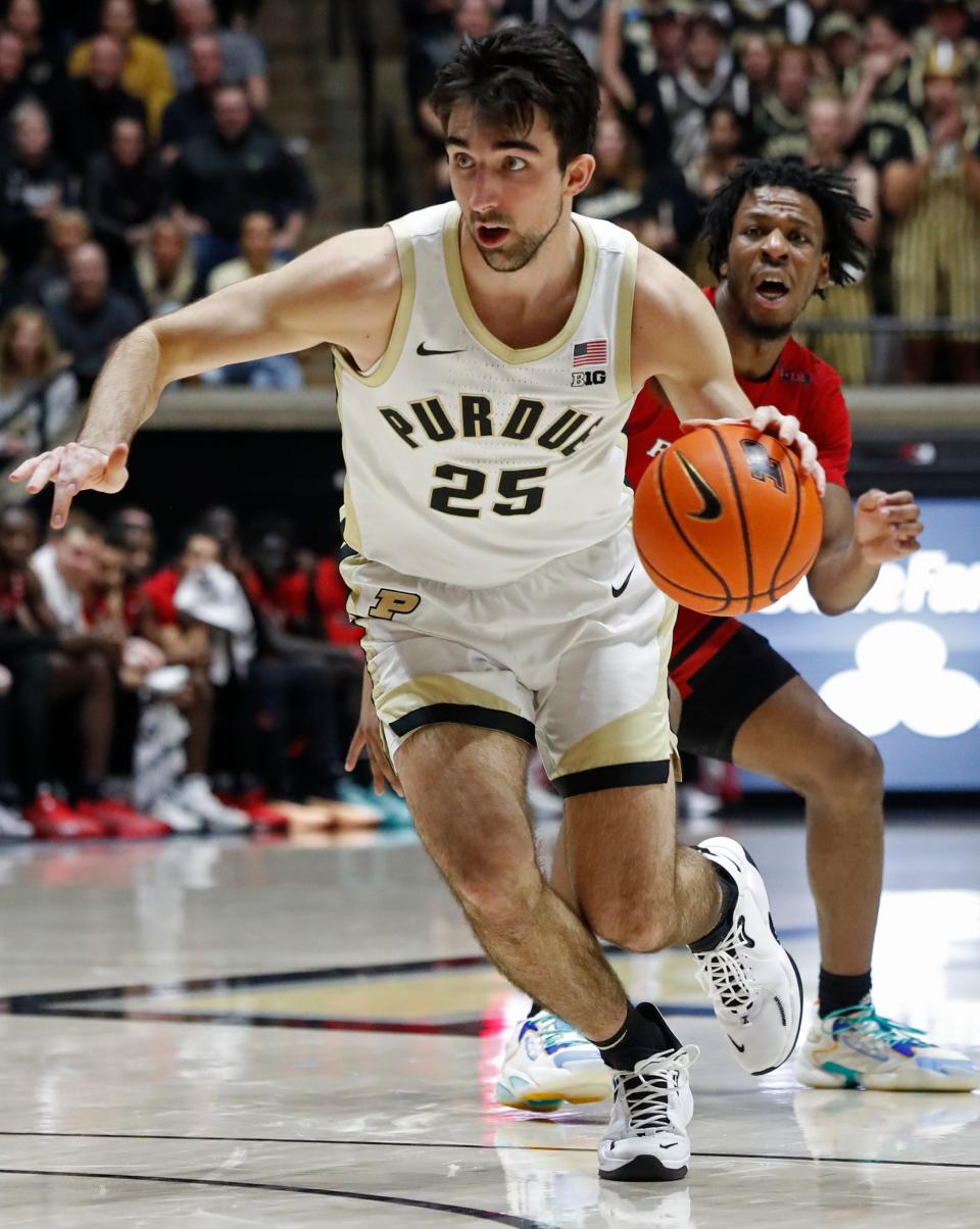 Purdue Boilermakers guard Ethan Morton (25) drives past Rutgers Scarlet Knights guard Jeremiah Williams (25) during the NCAA men’s basketball game, Thursday, Feb. 22, 2024, at Mackey Arena in West Lafayette, Ind. Purdue Boilermakers won 96-68.