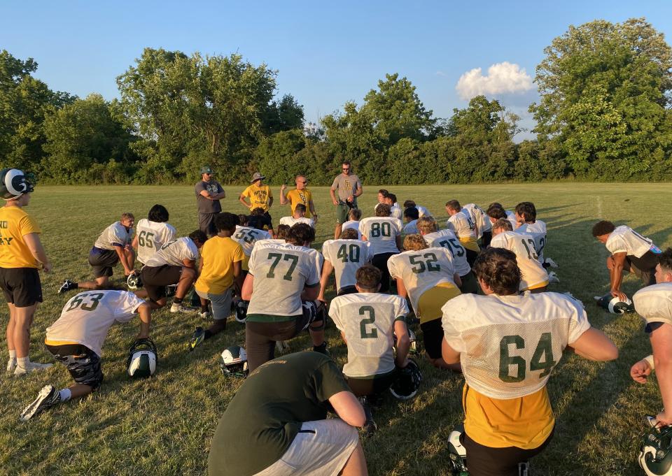 Flat Rock football coach Buck Reaume talks to his team during a recent practice.