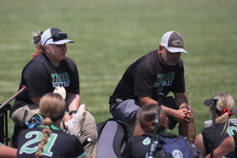 Yorktown softball head coach Jeremy Penrod (right) and assistant coach Sonya Willis talk to their team after losing 5-3 to Leo in the team's semistate game at Twin Lakes High School on Saturday, June 3, 2023.