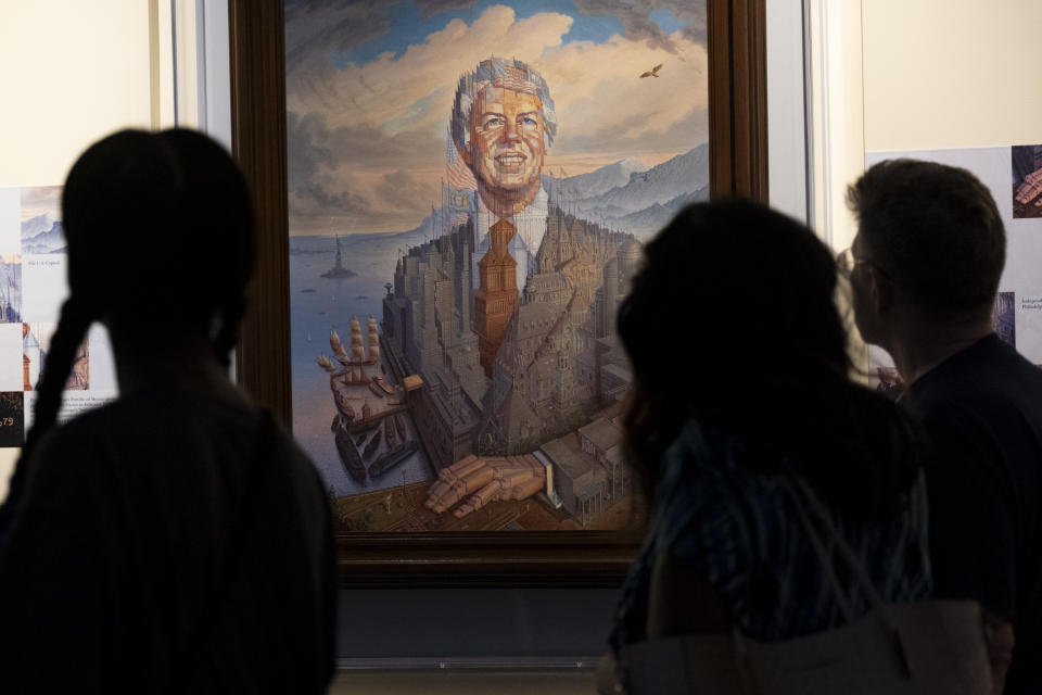 Visitors pass a portrait of President Jimmy Carter during a celebration of his 99th birthday held at The Carter Center in Atlanta on Saturday, Sept. 30, 2023. (AP Photo/Ben Gray)