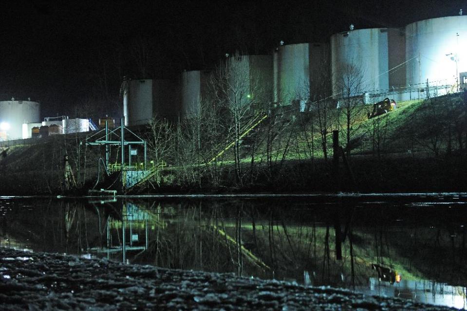 Crews clean up a chemical spill along the Elk River in Charleston, W.Va., which compromised the public water supply of eight counties on Thursday, Jan. 9, 2014. (AP Photo/Tyler Evert)