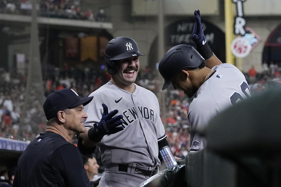 New York Yankees' Jasson Dominguez, right, is congratulated by manager Aaron Boone and Austin Wells after hitting a two-run home run against the Houston Astros during the first inning of a baseball game Friday, Sept. 1, 2023, in Houston. (AP Photo/Kevin M. Cox)