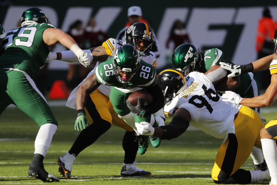 New York Jets running back Le'Veon Bell (26) dives with ball in front of Pittsburgh Steelers defensive tackle Isaiah Buggs (96) during the first half of an NFL football game, Sunday, Dec. 22, 2019, in East Rutherford, N.J. (AP Photo/Seth Wenig)