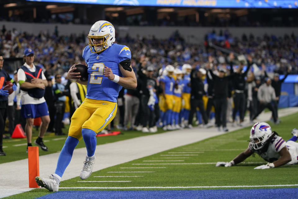 Los Angeles Chargers quarterback Easton Stick (2) scores a rushing touchdown against the Buffalo Bills during the first half of an NFL football game Saturday, Dec. 23, 2023, in Inglewood, Calif. (AP Photo/Ryan Sun)
