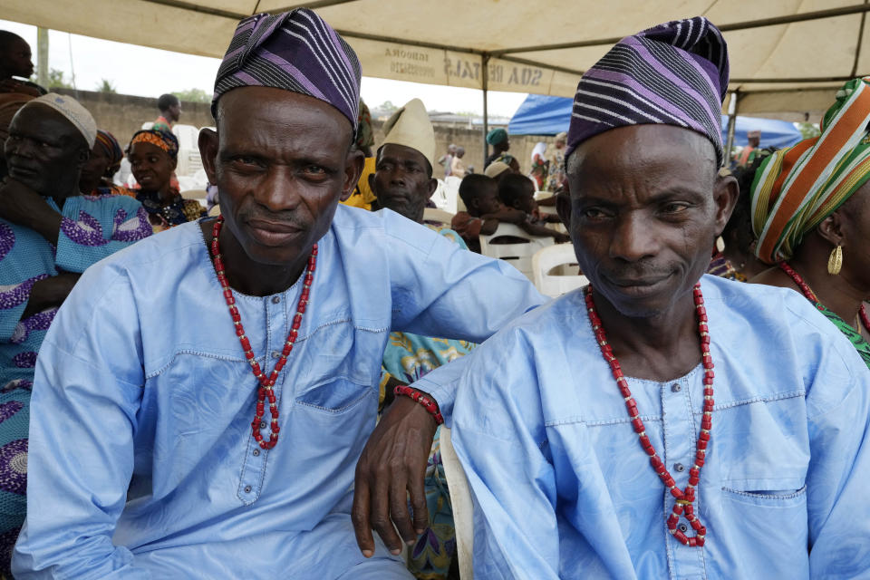 Twins Kehinde Oyediran, left, and Taiwo Oyediran, 52, cassava farmers from Igbo-ora attend the annual twins festival in Igbo-Ora South west Nigeria, Saturday, Oct. 8, 2022. The town holds the annual festival to celebrate the high number of twins and multiple births. (AP Photo/Sunday Alamba)