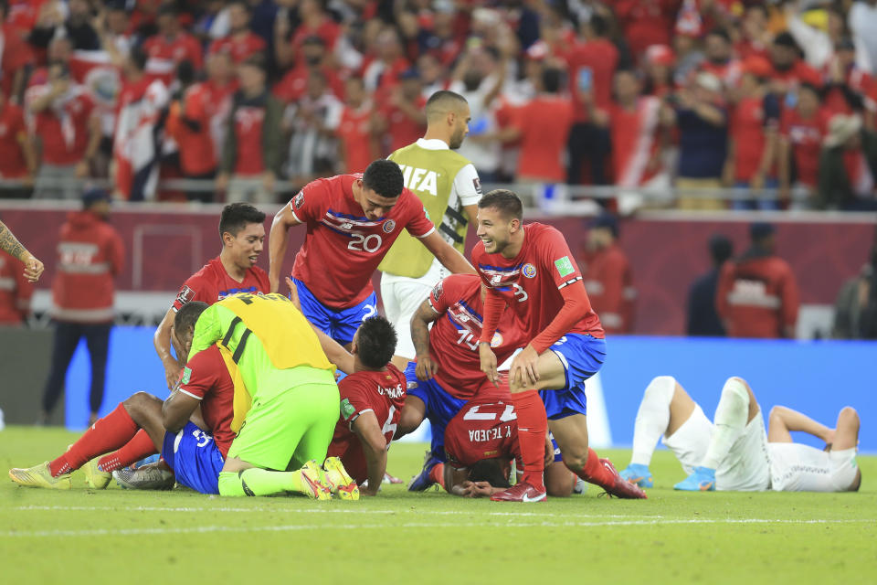 Costa Rica's players celebrate after the World Cup 2022 qualifying play-off soccer match between New Zealand and Costa Rica in Al Rayyan, Qatar, Tuesday, June 14, 2022. (AP Photo/Hussein Sayed)