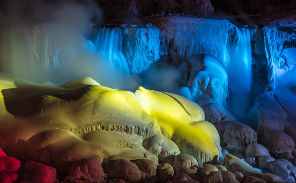 A partially frozen Niagara Falls is seen on American side lit by lights during sub freezing temperatures in Niagara Falls, Ontario March 3, 2014. REUTERS/Mark Blinch