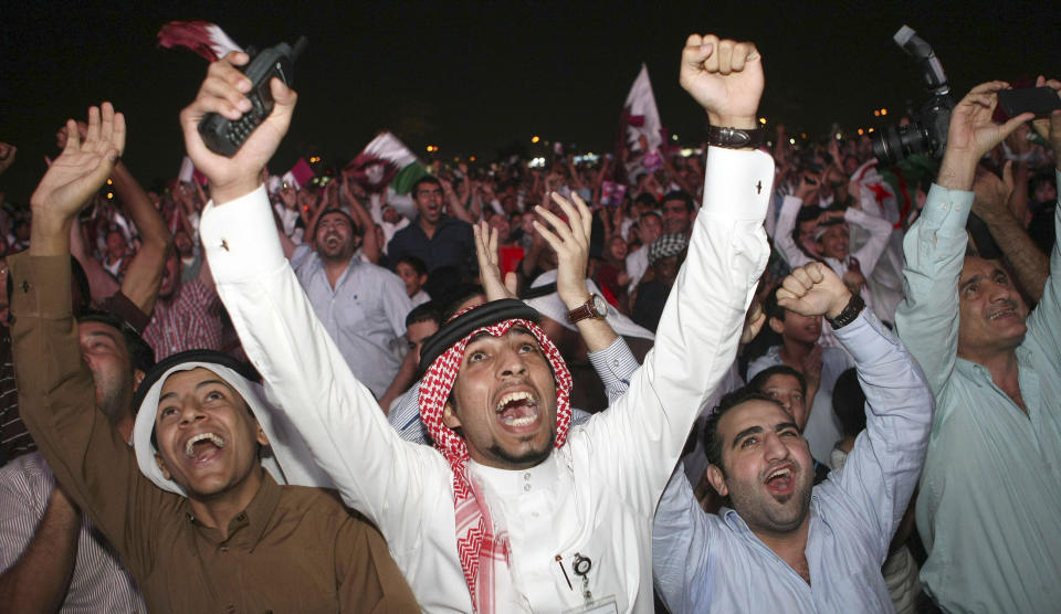 Qatari fans celebrate at Aspire Park in Doha December 2, 2010, after the announcement that Qatar will host the 2022 World Cup. Summer temperatures which can soar to above 50 degrees Celsius and a concern about lack of infrastructure did not deter FIFA on Thursday from awarding the 2022 World Cup to the tiny Gulf state of Qatar. REUTERS/Stringer (QATAR - Tags: SPORT SOCCER)