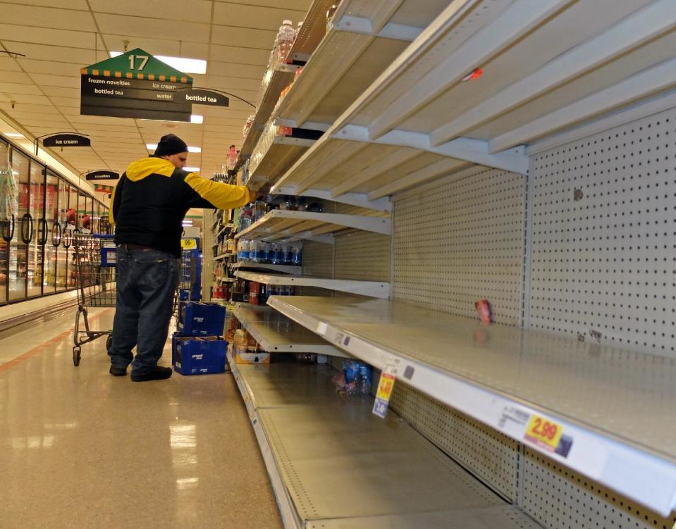 Jim Cole of Exeter, N.H., got the last few bottles of water at the Kroger in South Charleston W.Va. following a chemical spill on the Elk River that compromised the public water supply to eight counties of Thursday, Jan. 9, 2014. (AP Photo/Tyler Evert)