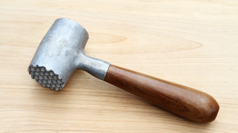 meat mallet on cutting board