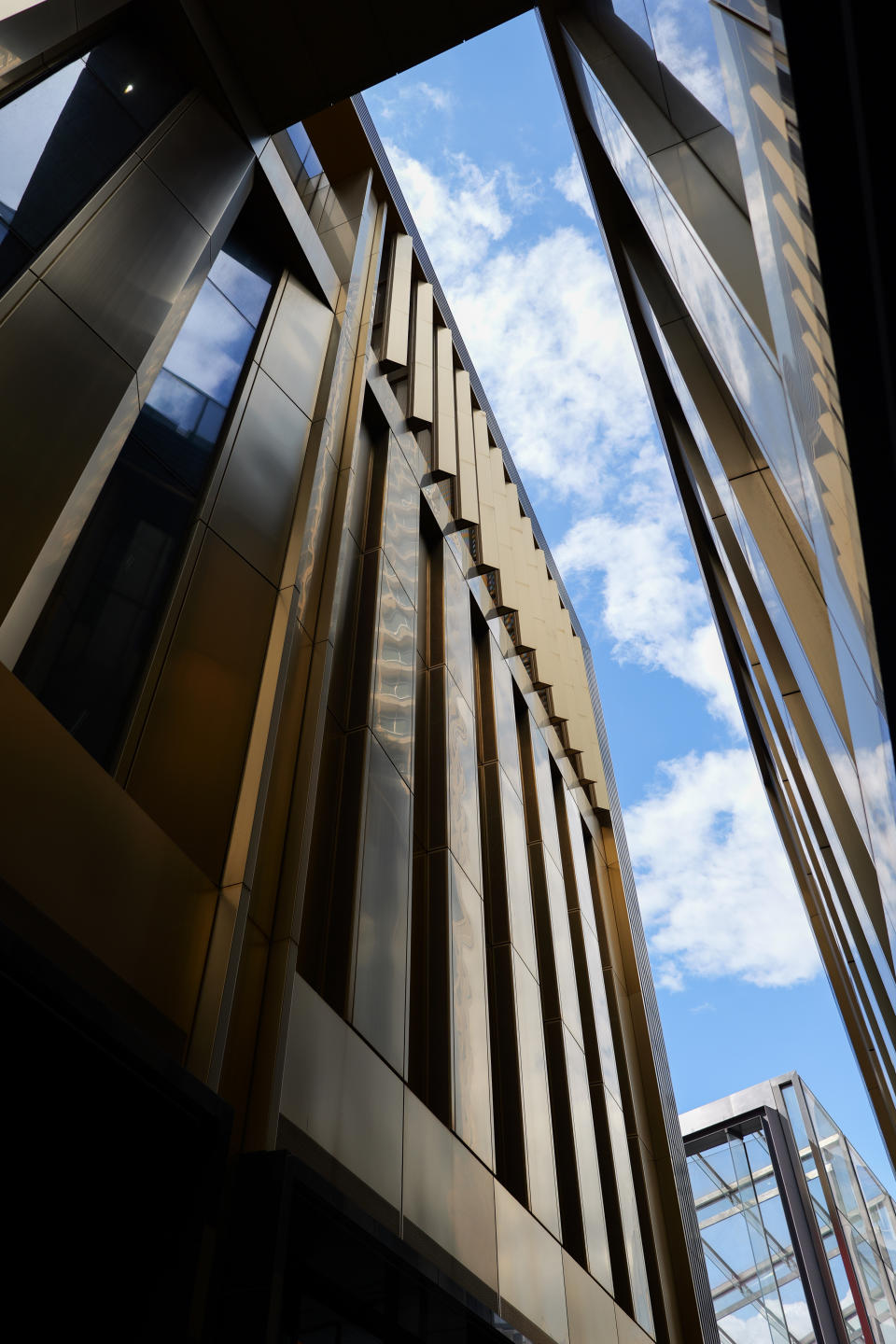 View of the sky between tall buildings in London